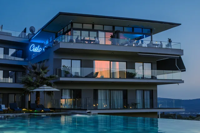 Royal Blue — poolside exterior and Cielo sign at blue hour
