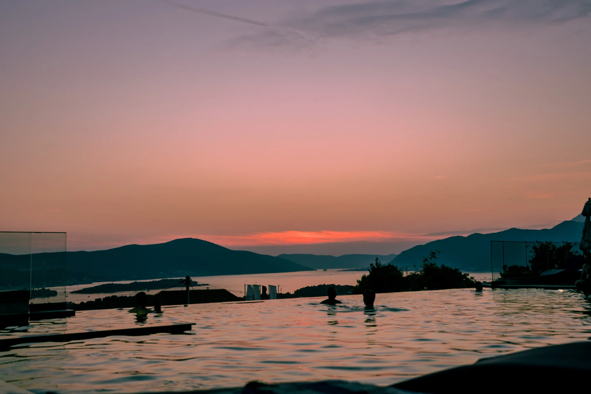 The Royal Blue pool overlooking the bay and hills at sunset