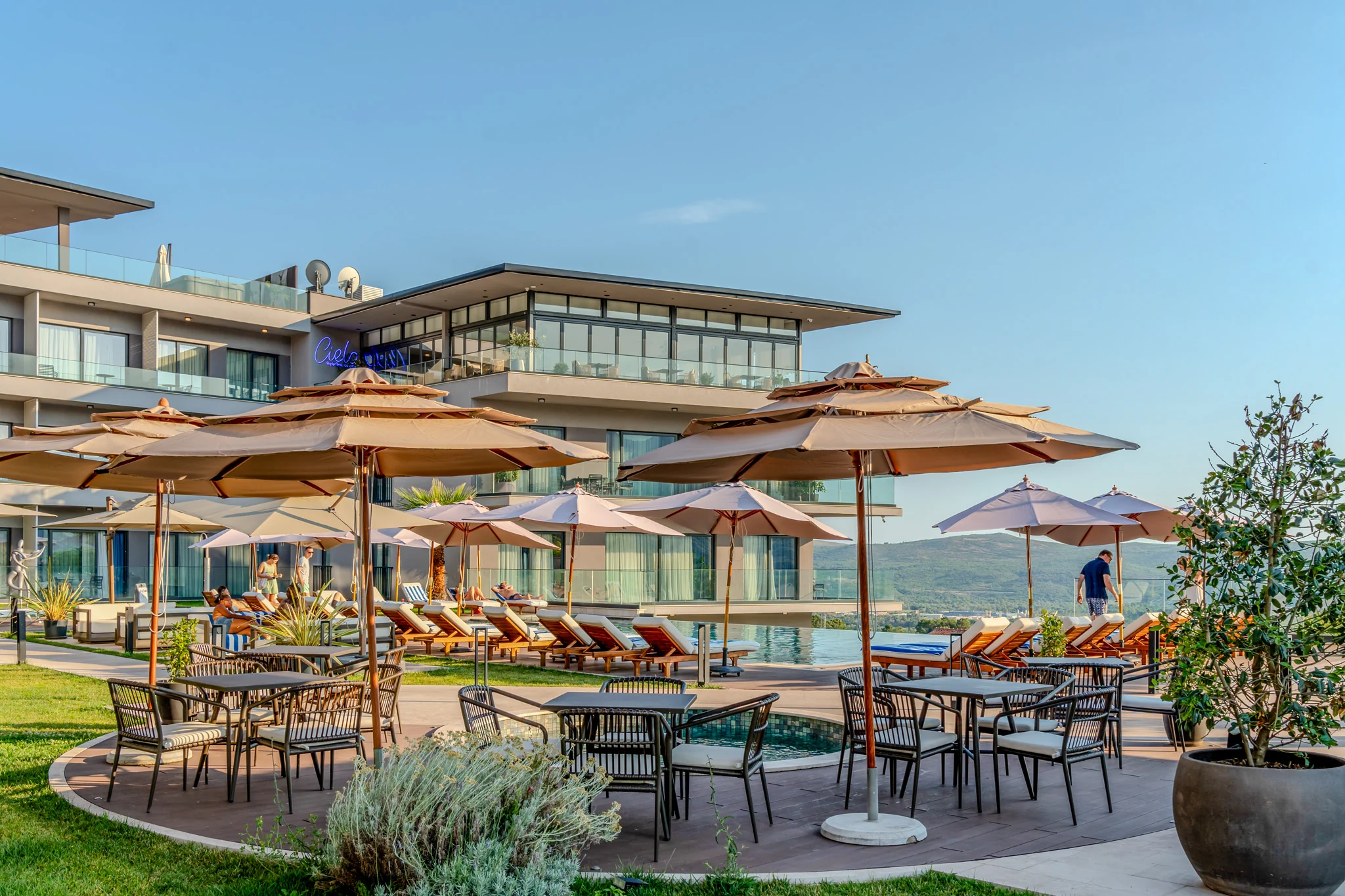Pool terrace, loungers and residences at Royal Blue Resort & Residences